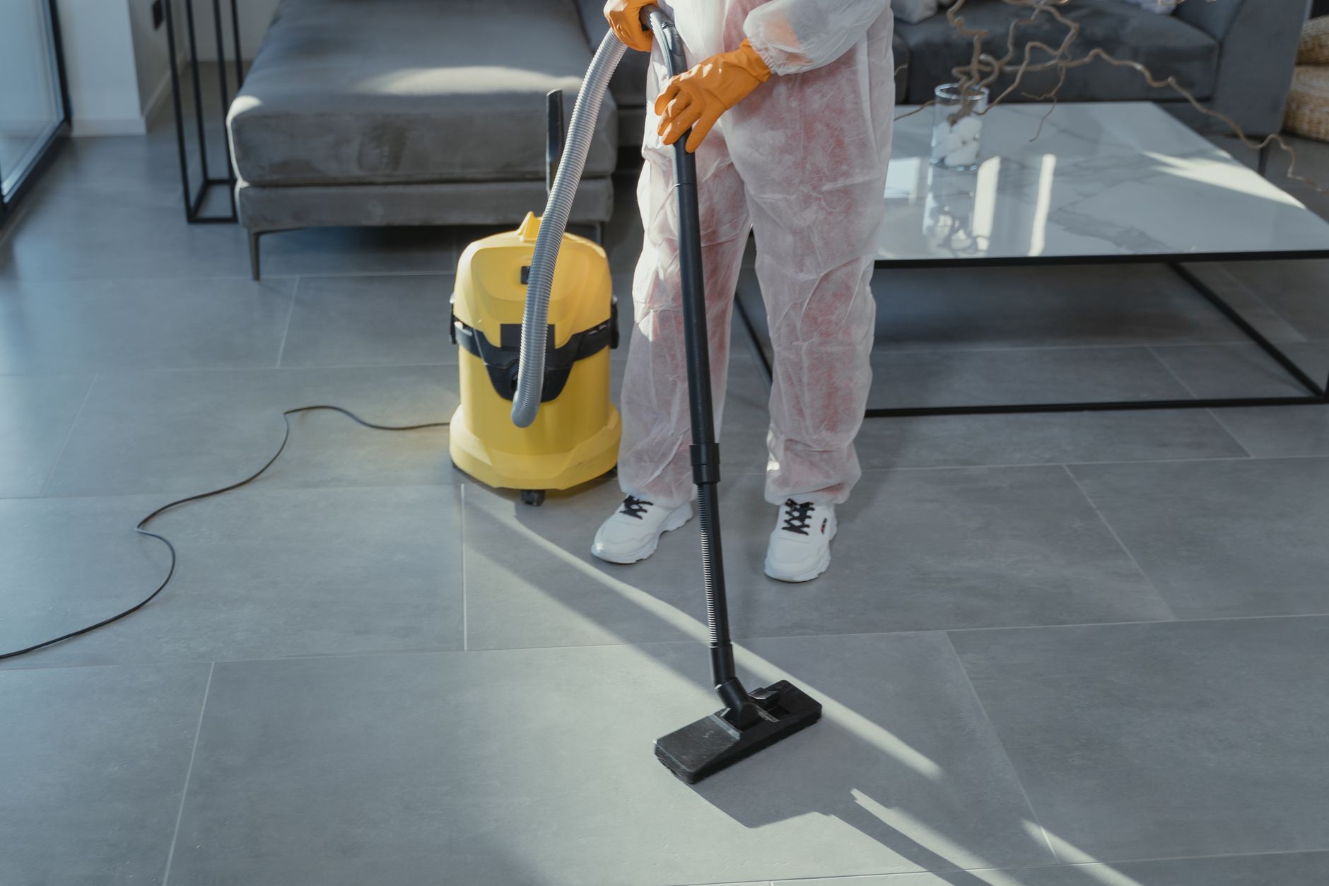 A Coastal Pro Mold Removal technician explaining a remediation plan to a homeowner in a clean, restored living room in Indian Creek, Texas.